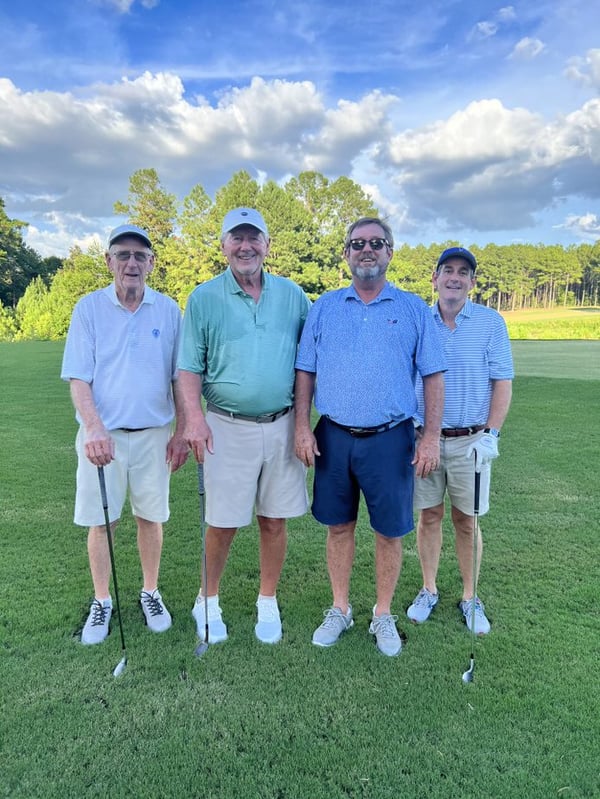 gentlemen on golf green at fundraiser