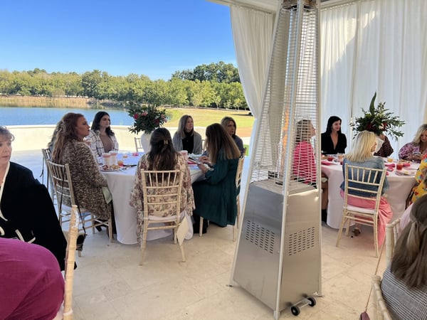 women seated at round tables at fundraiser