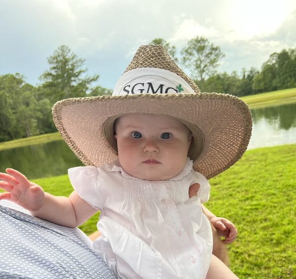 adorable baby wearing large hat