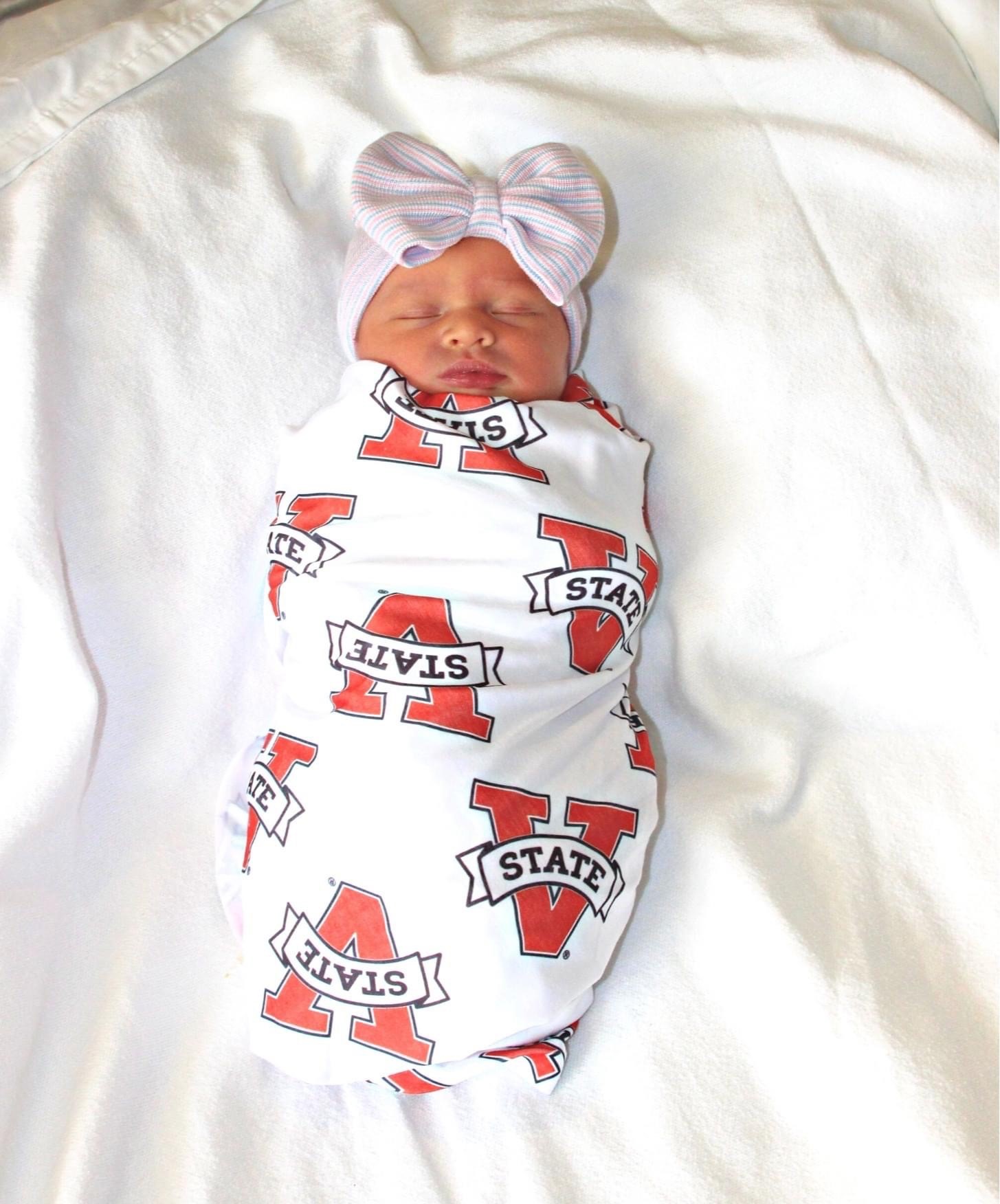 Baby swaddled in valdosta state cloth