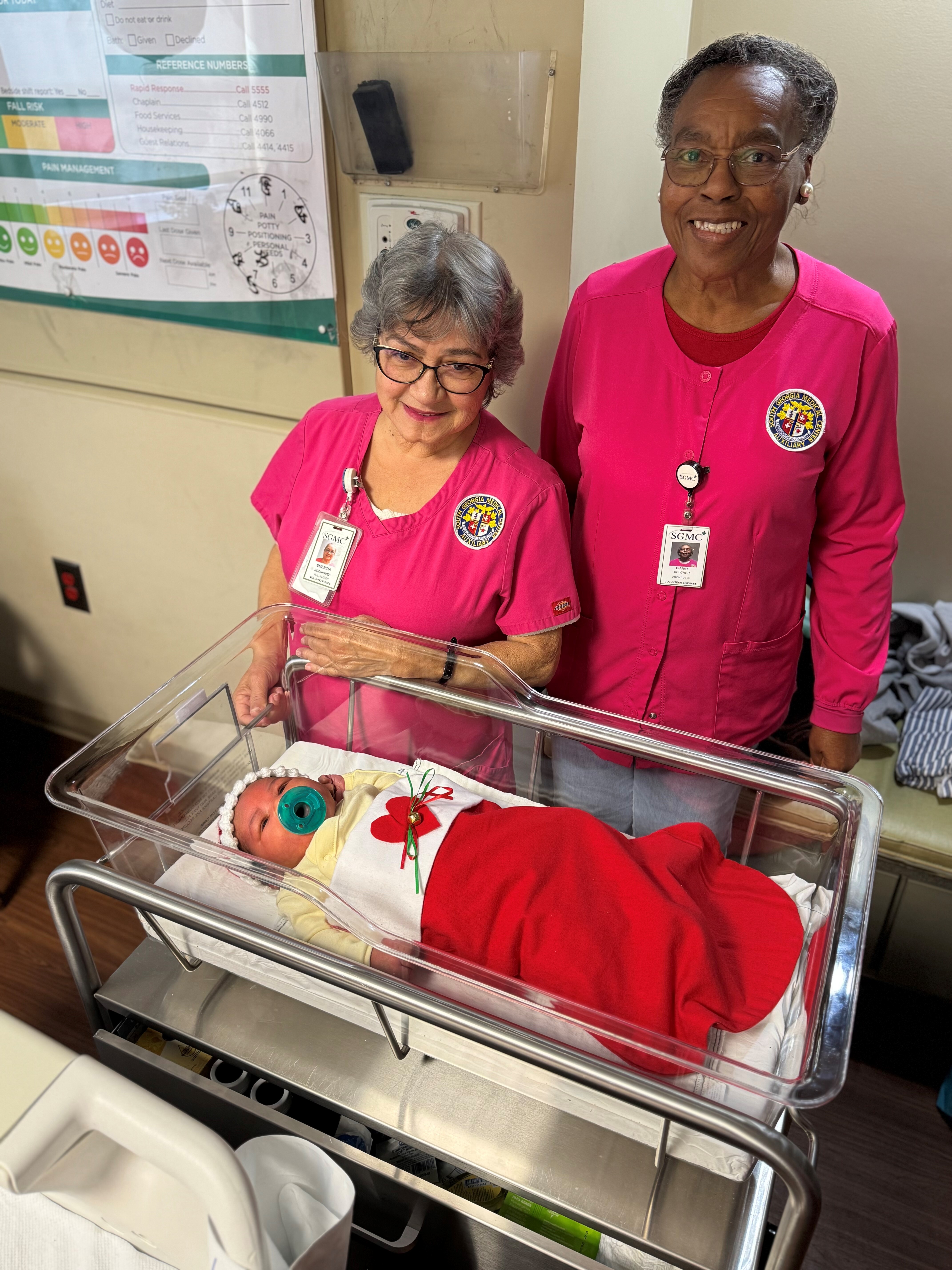 Volunteers and baby in stocking