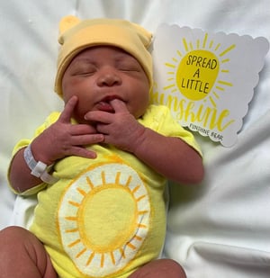 baby dressed as a carebear