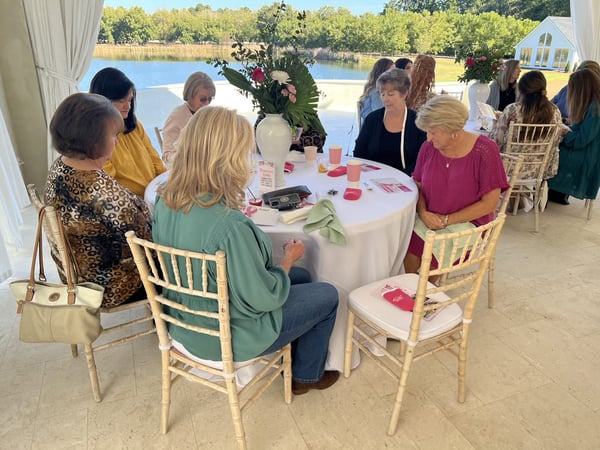 women seated at round table at fundraiser