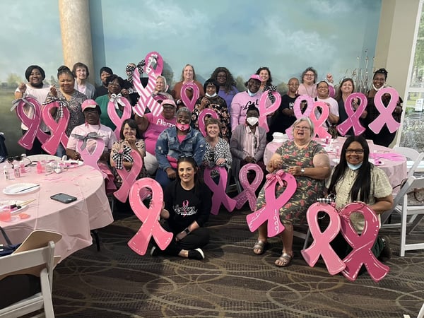 women with pink ribbons at fundraiser